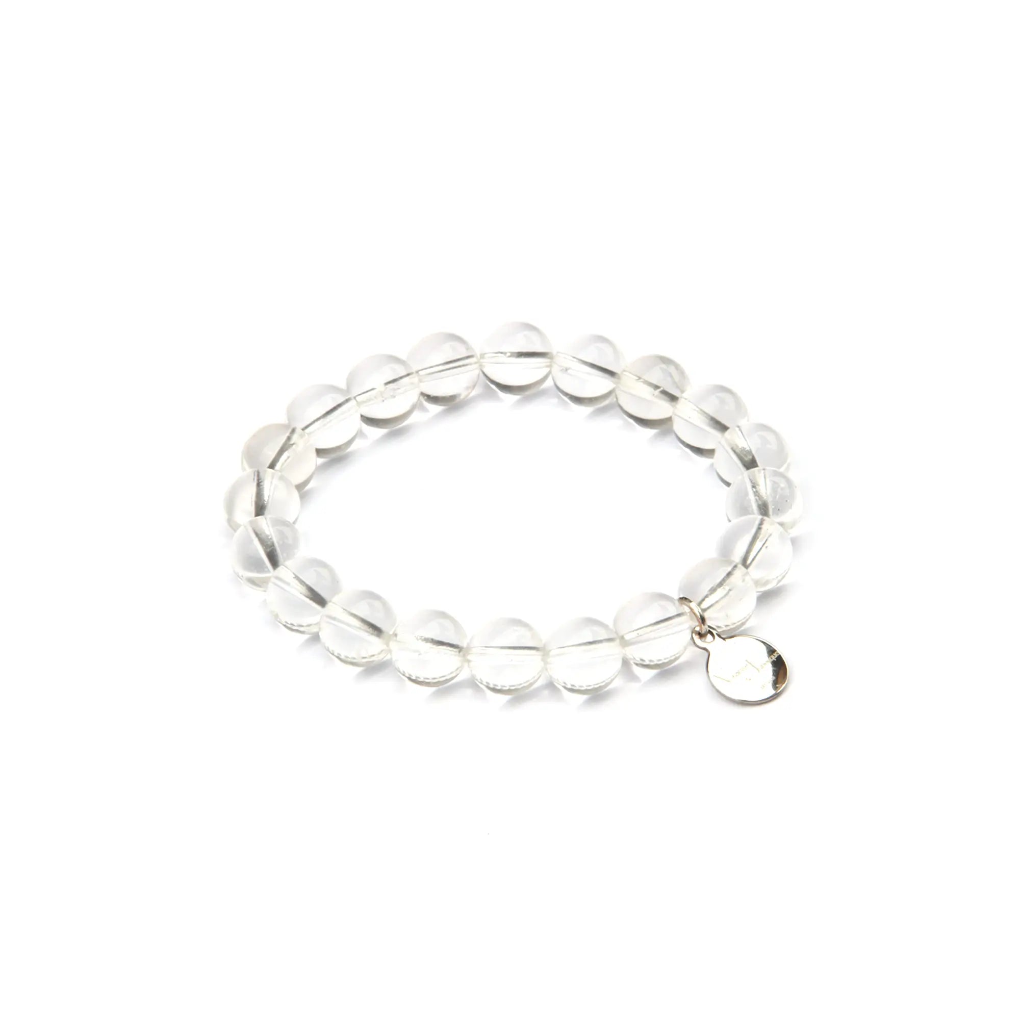 A clear beaded stretch bracelet made of faceted round beads with a small silver-tone oval charm, shown on a plain white background.