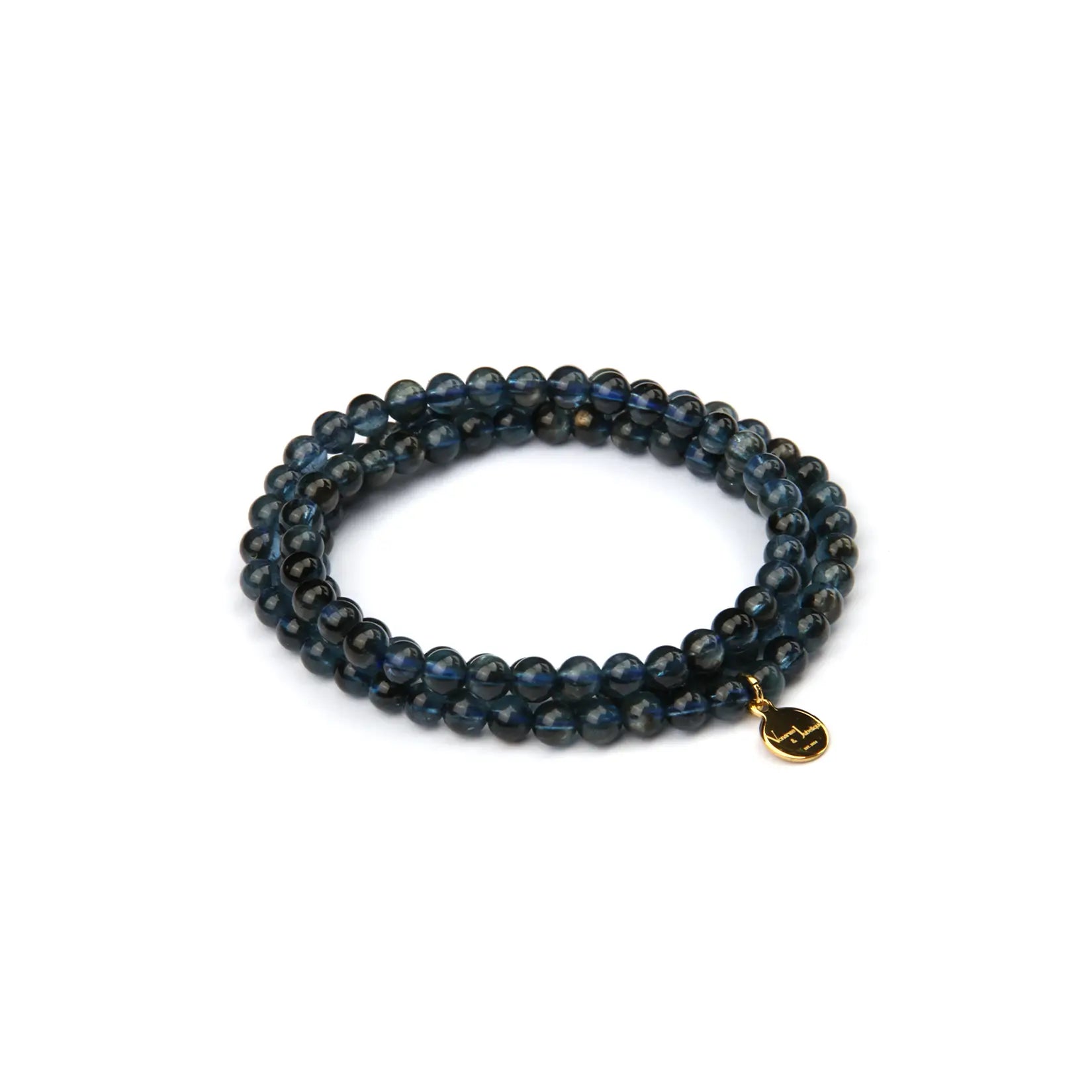 A beaded stretch bracelet made of dark blue and black labradorite beads, featuring a small gold-toned circular charm, shown on a plain white background.