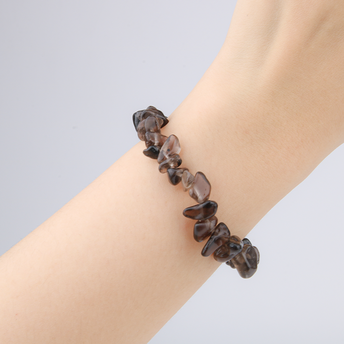 Minimalist chip crystal bracelet with raw-shaped smoky quartz stones, featuring a grounding and natural crystal aesthetic