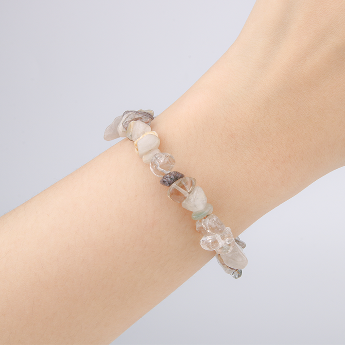 Minimalist chip crystal bracelet with raw-shaped bronze rutilated quartz, showcasing shimmering inclusions and a natural crystal elegance