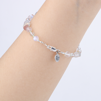 Delicate beaded bracelet with blue moonstone, clear quartz, strawberry rose quartz, aquamarine, and peridot in raw or round-shaped beads