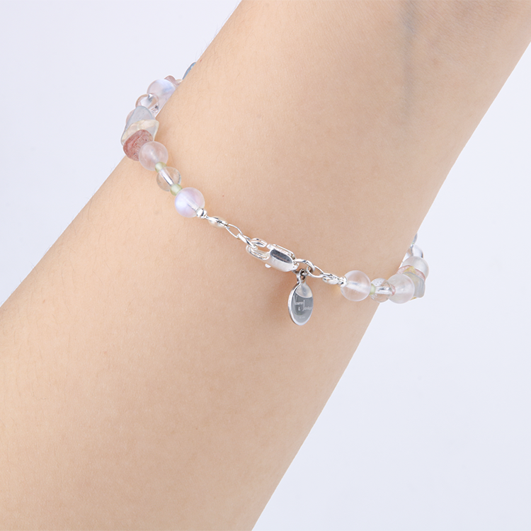 Delicate beaded bracelet with blue moonstone, clear quartz, strawberry rose quartz, aquamarine, and peridot in raw or round-shaped beads