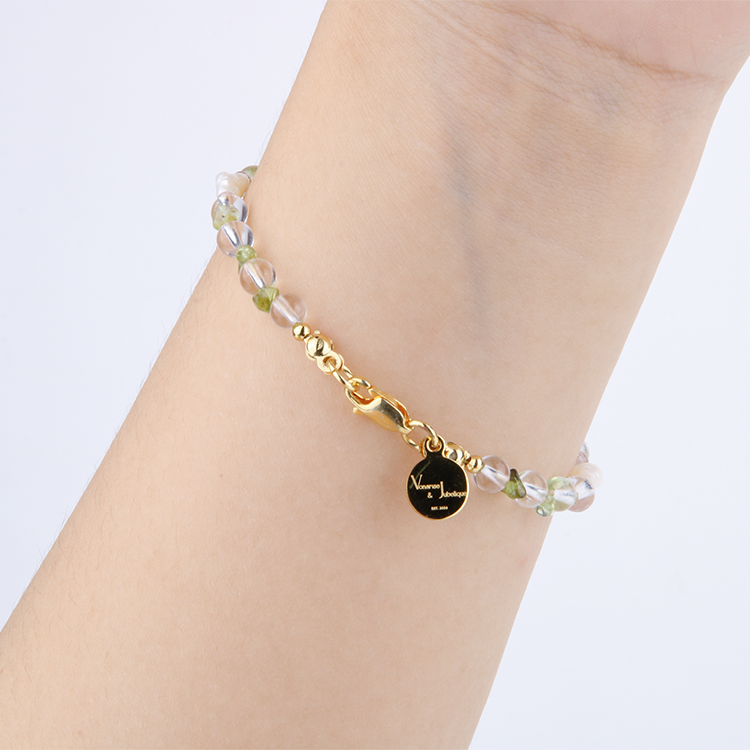 Minimalist bracelet with raw-shaped peridot, strawberry rose quartz, opal, clear quartz, and freshwater pearl