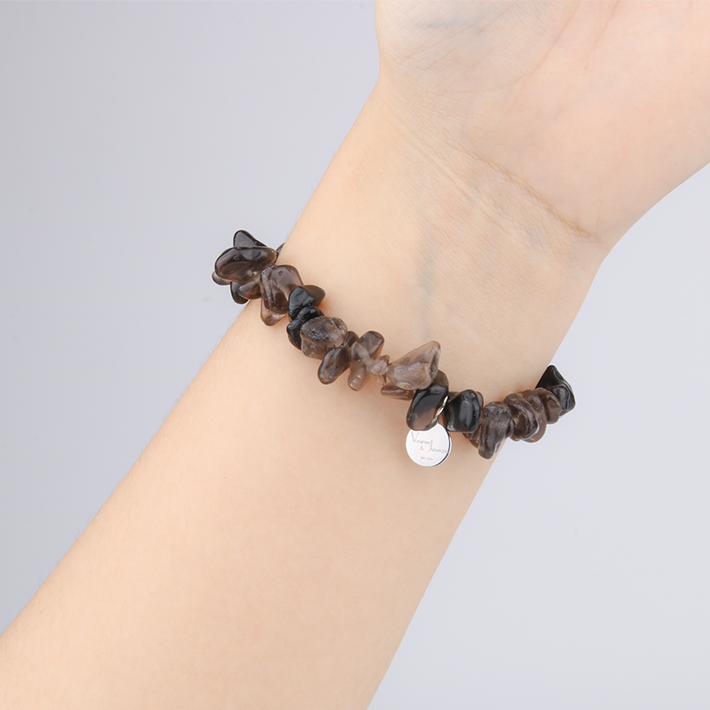 Minimalist chip crystal bracelet with raw-shaped smoky quartz stones, featuring a grounding and natural crystal aesthetic