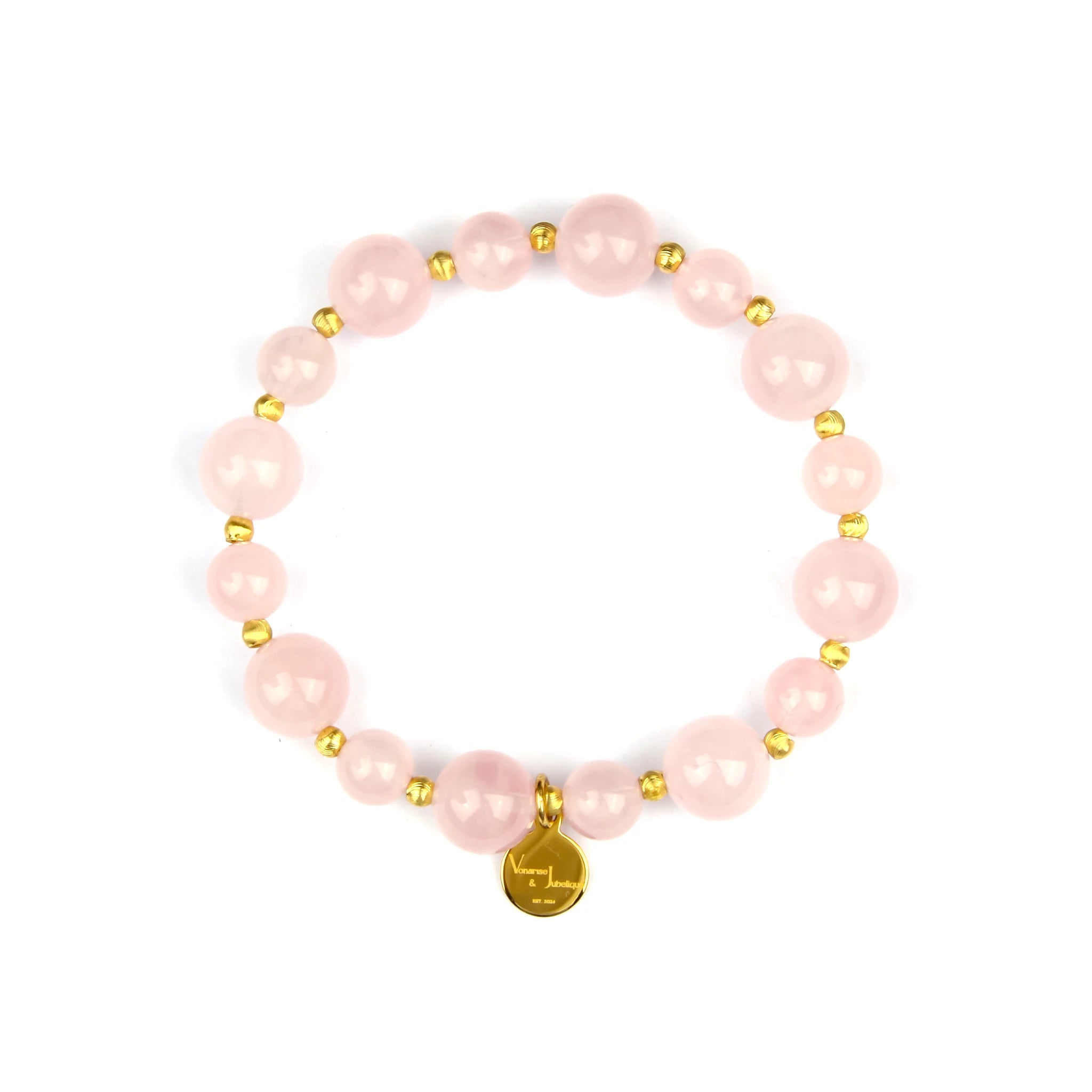 A pink beaded stretch bracelet featuring large round pink beads, small metallic gold spacer beads, and a gold circular charm at the bottom, displayed on a clean white background.