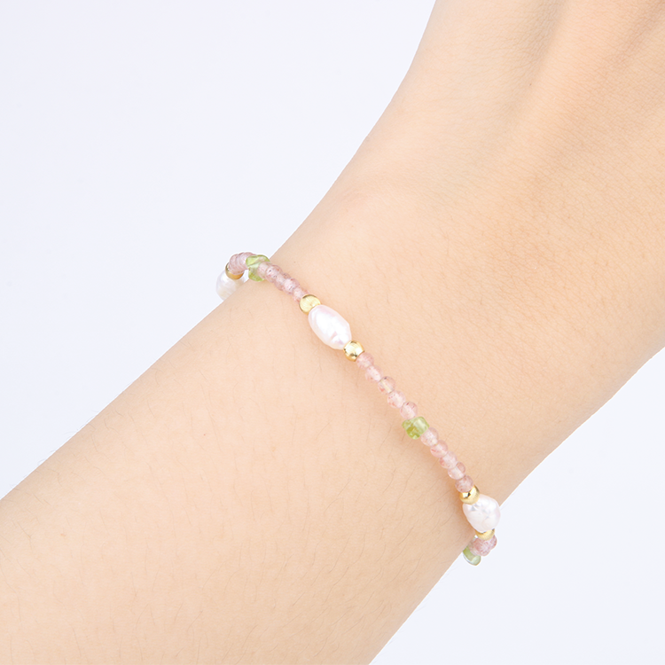 Delicate bracelet featuring blue moonstone, round strawberry rose quartz, and raw-shaped peridot in a minimalist design