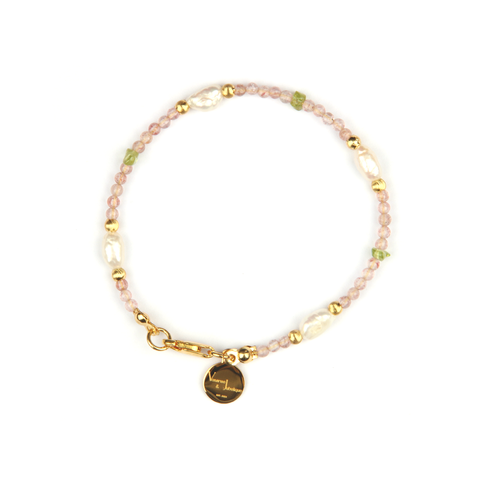 Delicate bracelet featuring blue moonstone, round strawberry rose quartz, and raw-shaped peridot in a minimalist design