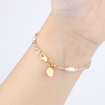 Delicate bracelet featuring blue moonstone, round strawberry rose quartz, and raw-shaped peridot in a minimalist design