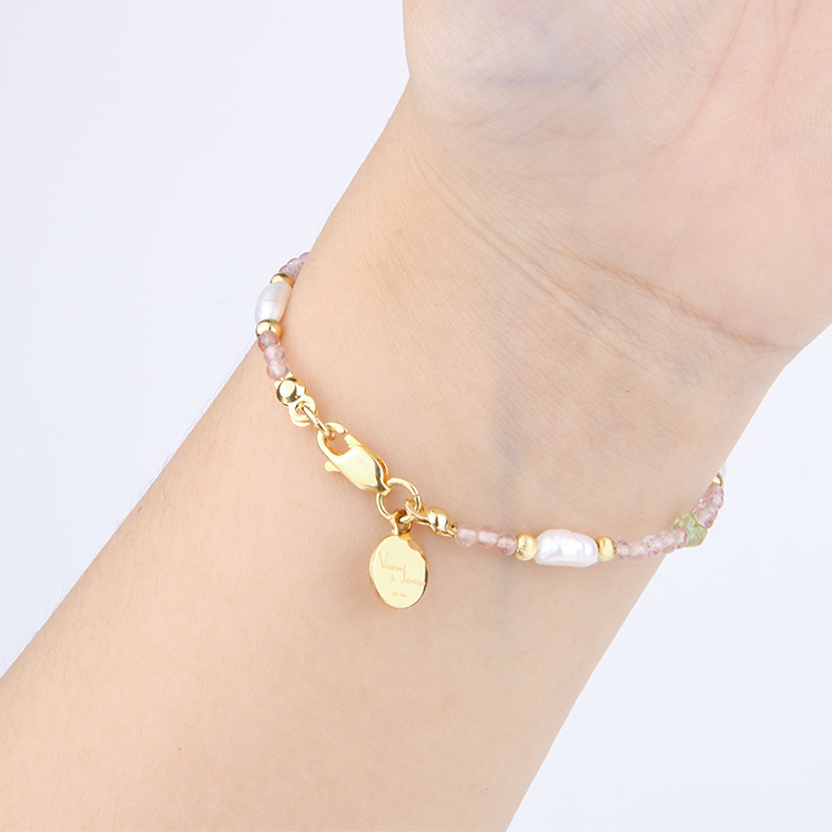Delicate bracelet featuring blue moonstone, round strawberry rose quartz, and raw-shaped peridot in a minimalist design